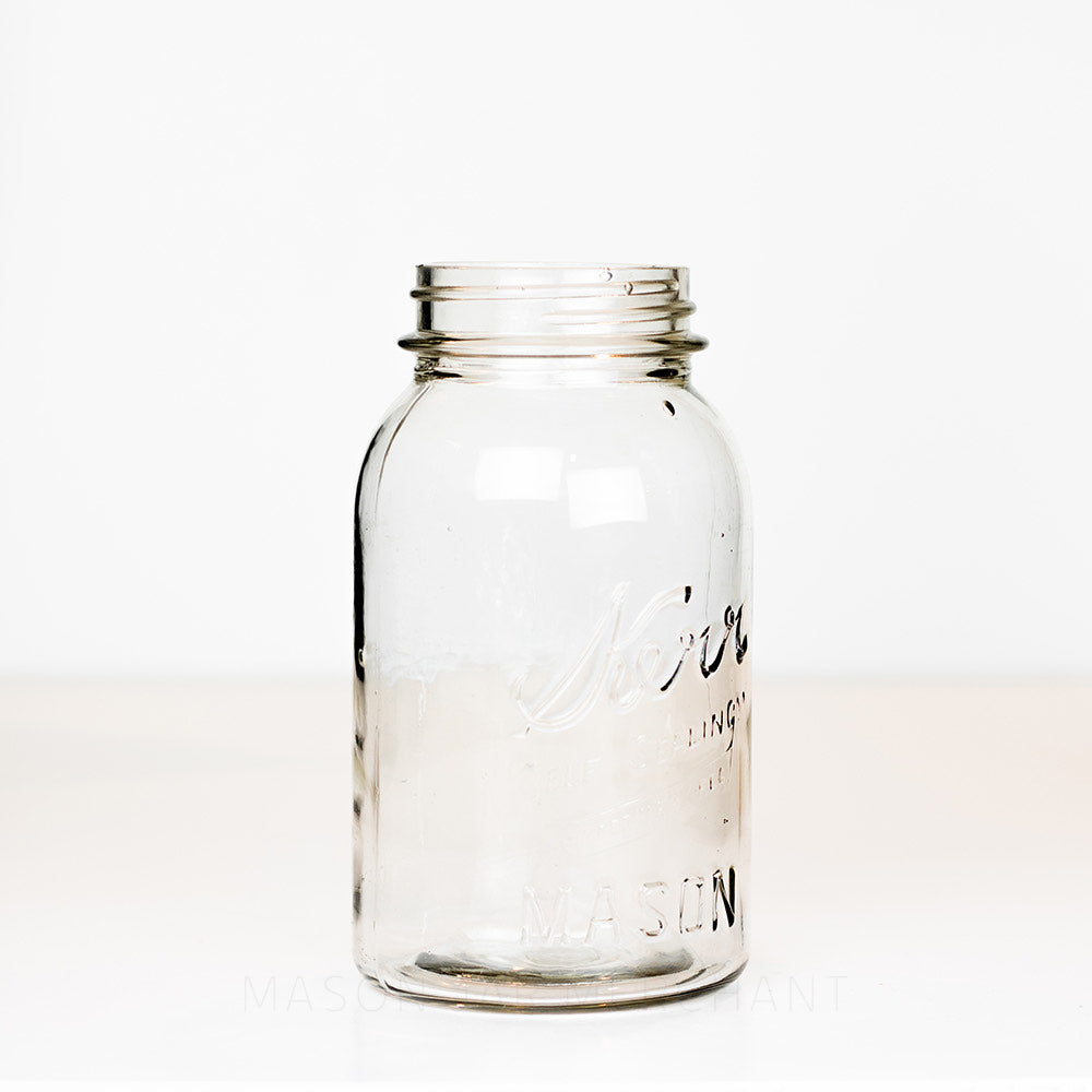 Side view of a vintage quart Kerr mason jar against a white background