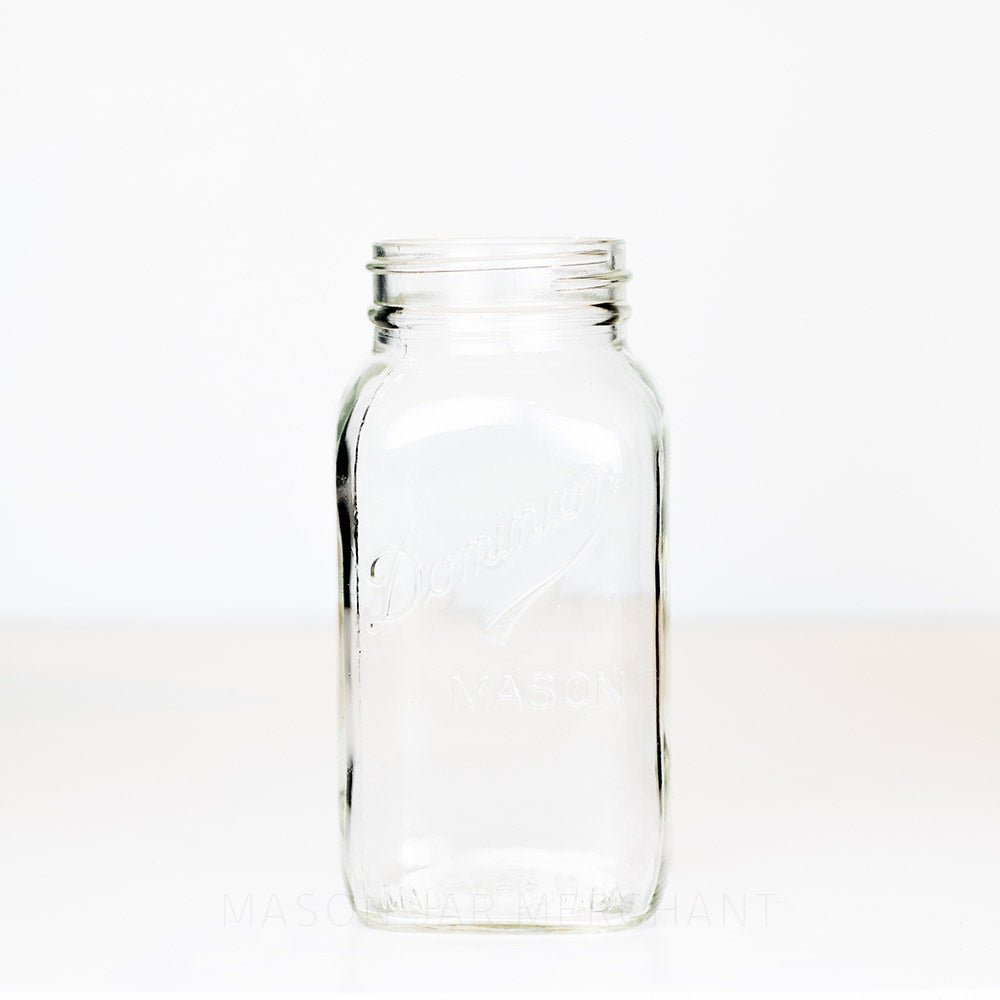 Dominion brand regular mouth mason jar on a white background