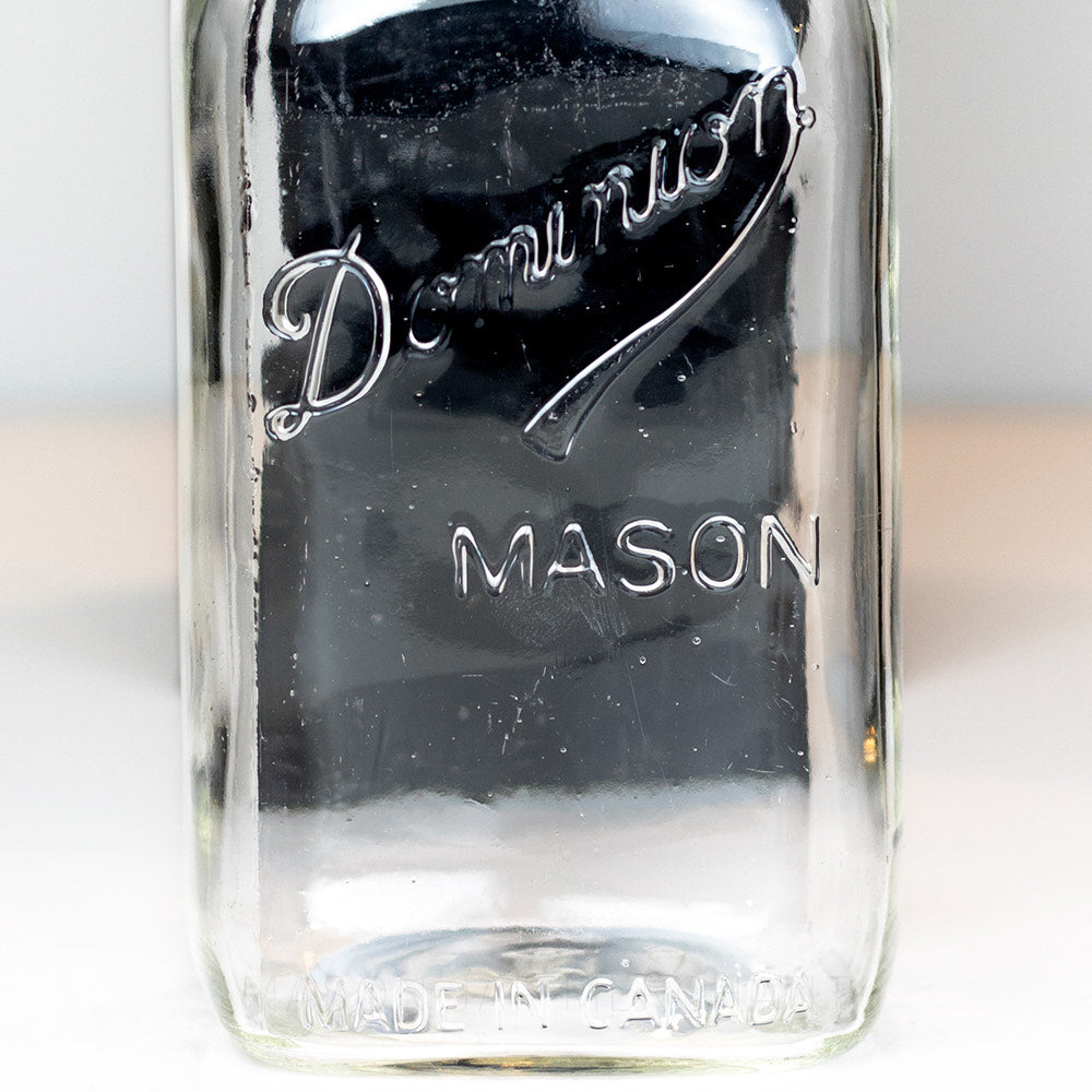 Close-up of a Dominion Mason logo on a quart mason jar