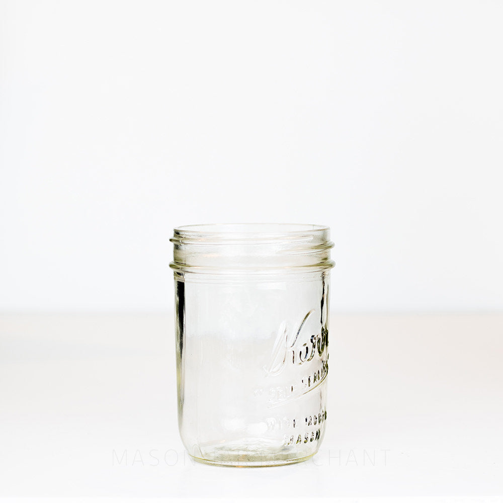 Side view of a Kerr &quot;self sealing&quot; glass mason jar on a white background