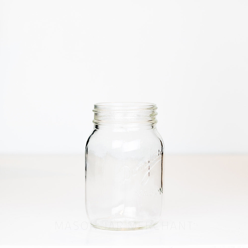 Regular mouth pint mason jar with Domglas logo on a white background