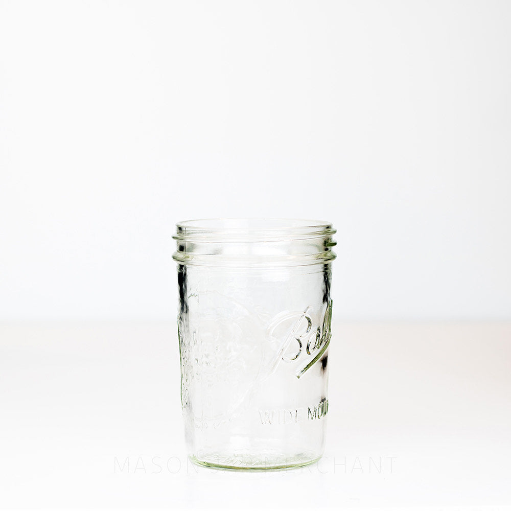 Side view of a Wide mouth pint Ball mason jar against a white background