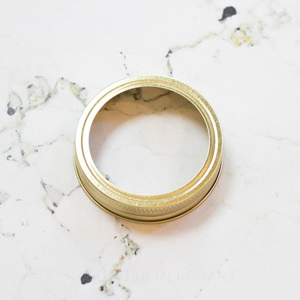 close up of a regular mouth canning ring on a white marble background
