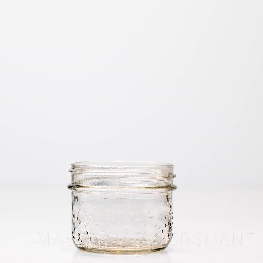 Wide mouth half pint mason jar with a speckled exterior, against a white background