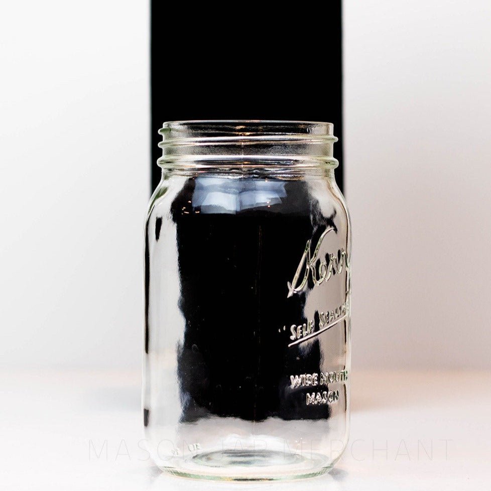 Side view of a wide mouth quart mason jar with Kerr self-sealing logo against a white background