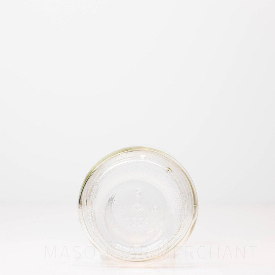 Bottom of a Regular mouth pint mason jar with soft &quot;shoulders&quot; and no logo, against a white background