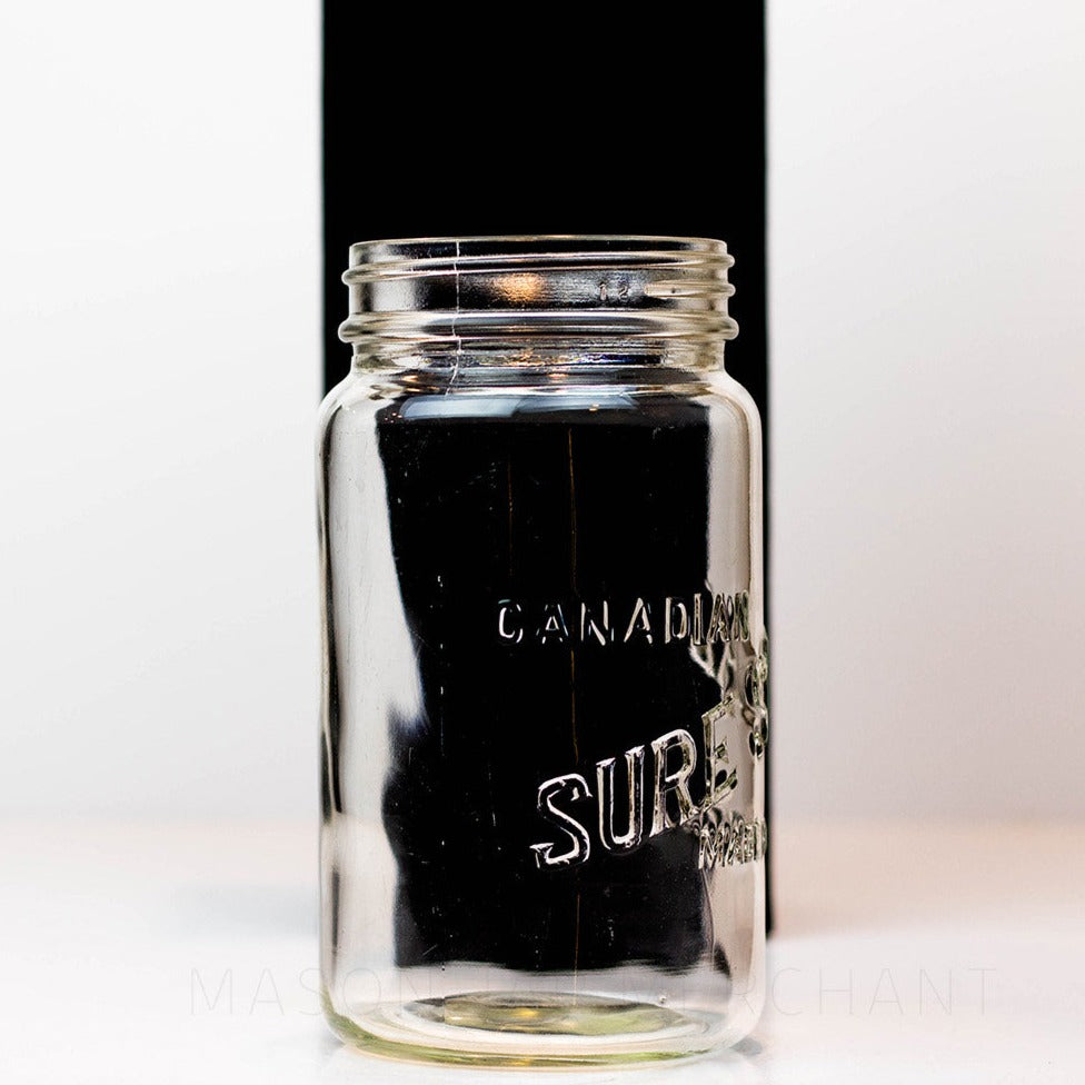 A side view close up of a Canadian Sure Seal wide mouth quart mason jar against a white background