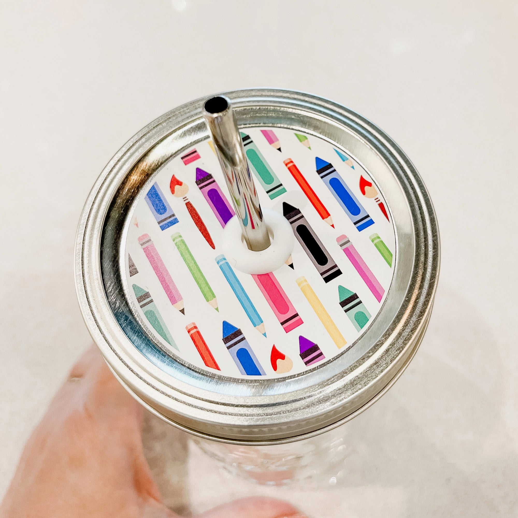 A Patterned Mason Jar Straw Lid with Colourful Pencils & Crayons design