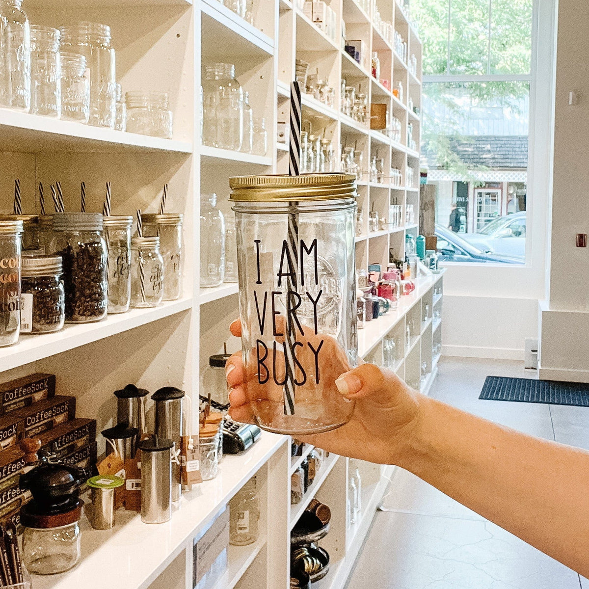 Photo of a mason jar tumblr with a &#39;I am very busy&#39; sticker on it