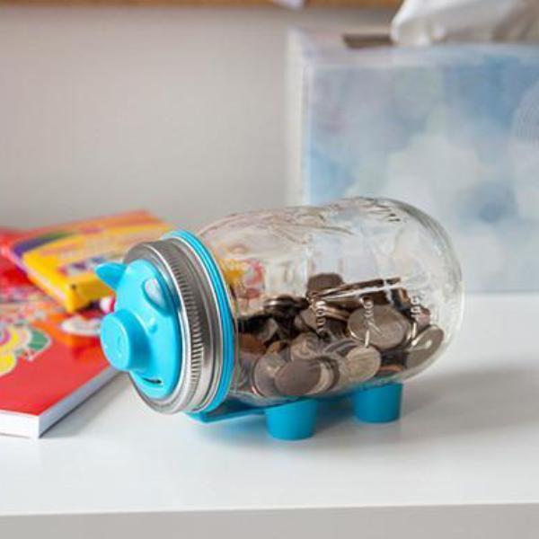 16 oz reusable glass mason jar with a silver and blue piggy bank lid. The jar is on its side and made to look like a pig