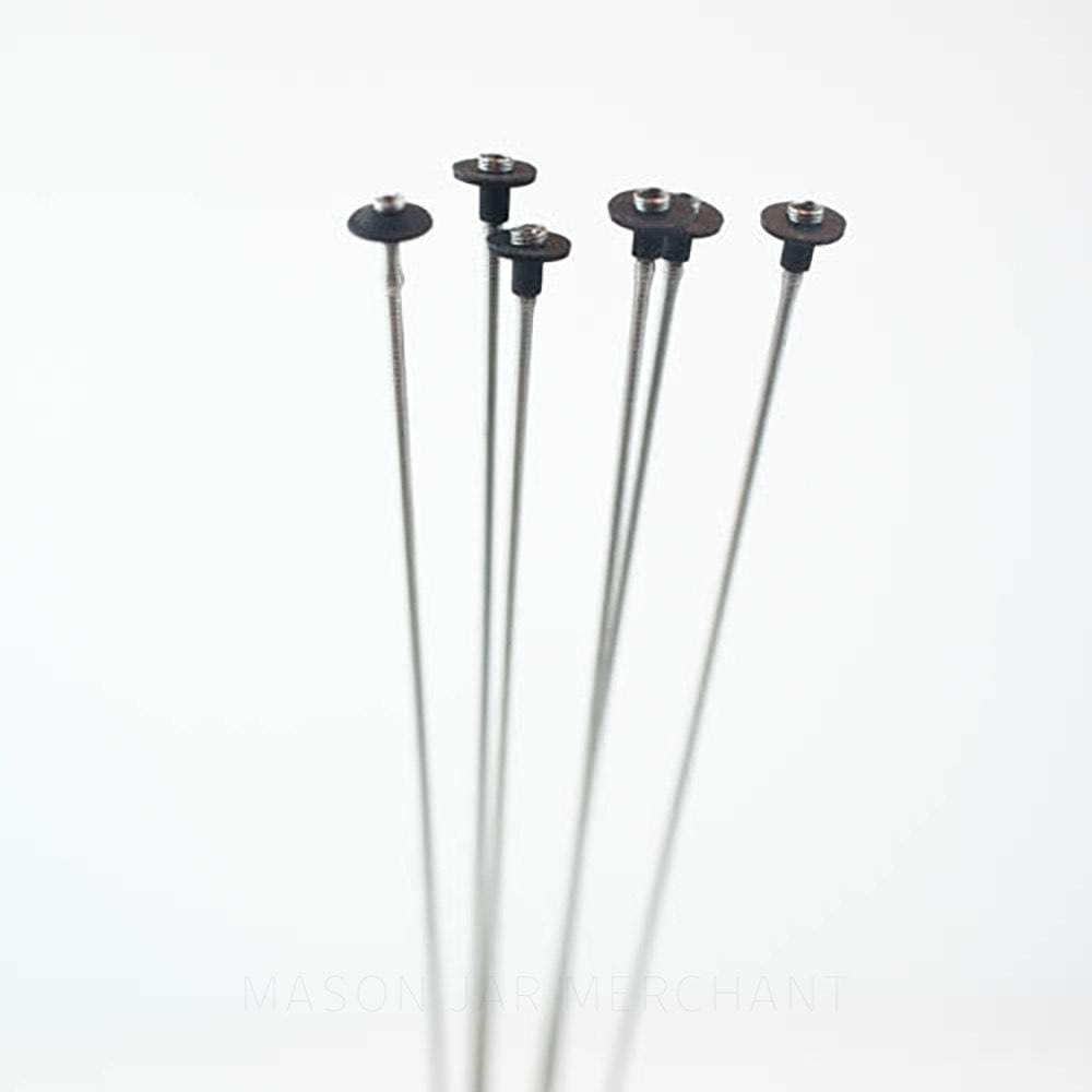 a close up of a bunch of straw cleaners in a glass mason jar