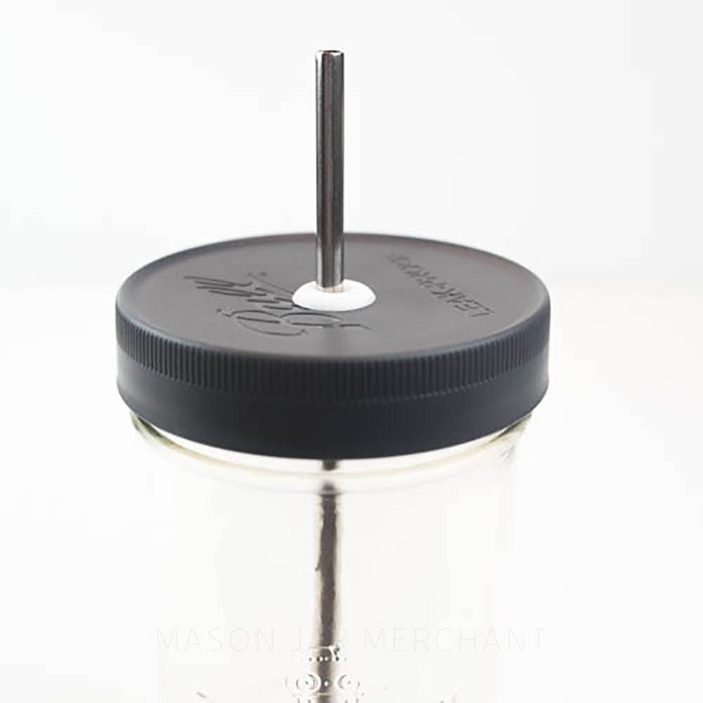 close up of an all black plastic mason jar Ball straw lid on a glass mason jar with a black metal straw in it