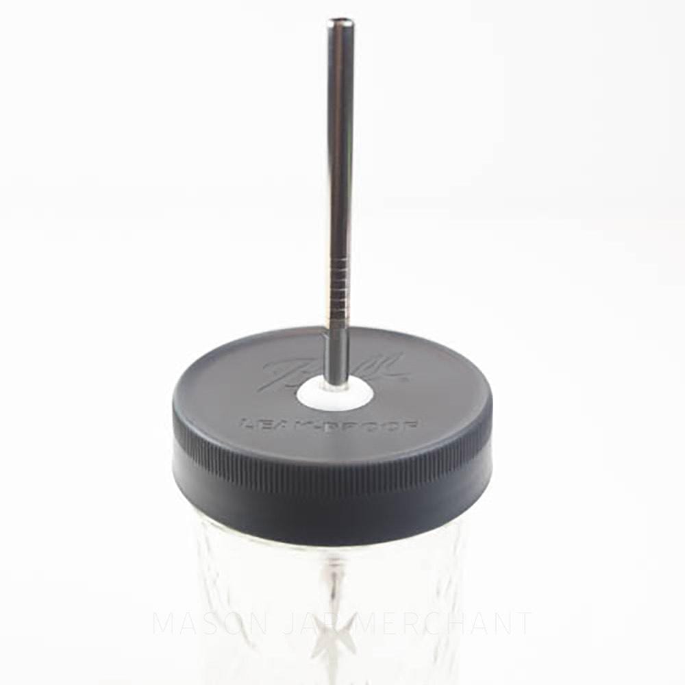 close up of an all black plastic mason jar Ball straw lid on a glass mason jar with a black metal straw in it