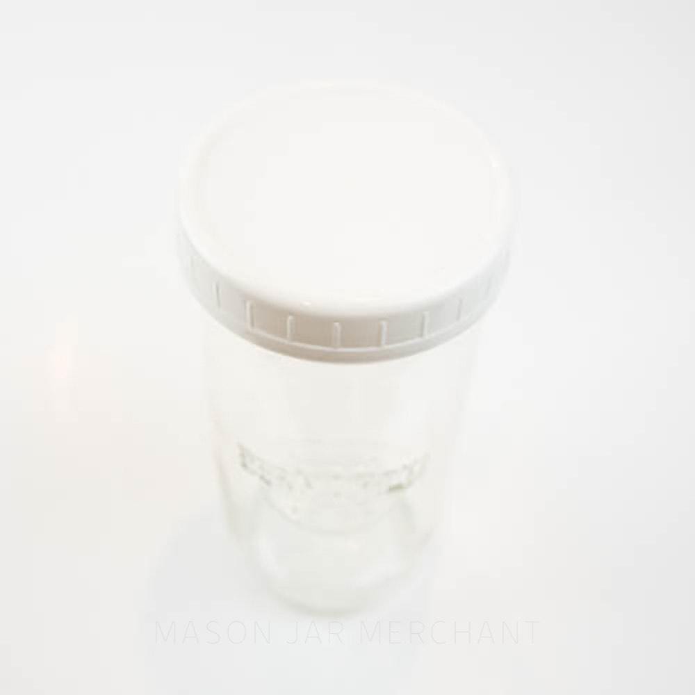 White plastic storage lid on a wide mouth mason jar against a white background