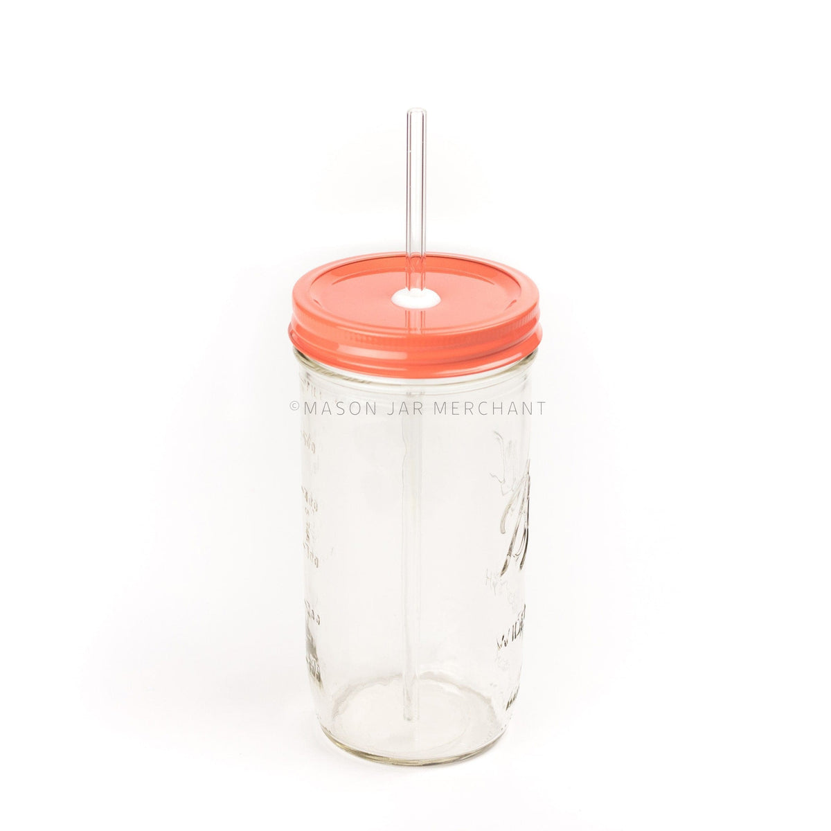 A 24 oz mason jar with a coral coloured custom painted lid with a white silicone grommet and a glass straw, against a white background