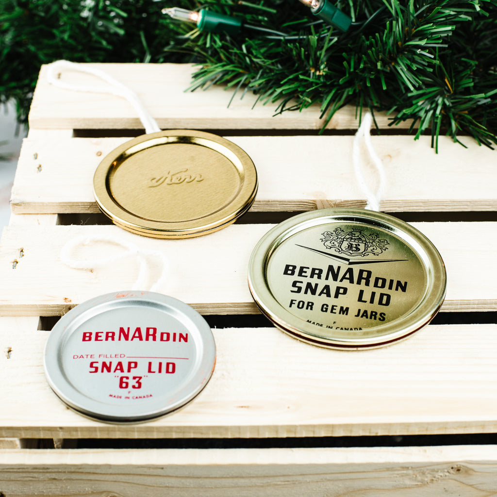 three Christmas ornaments made from used Kerr and Bernardin mason jar flat lids