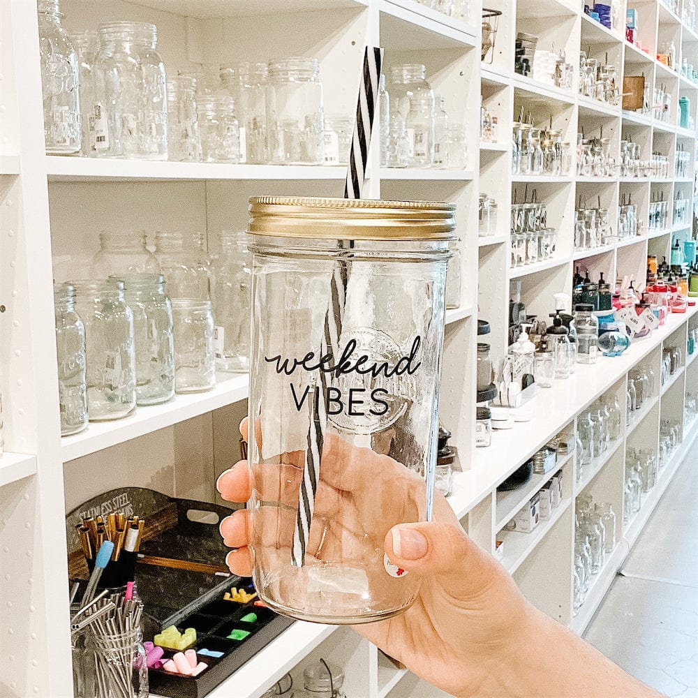 A photo of a mason jar tumblr with a sticker text that says " Weekend vibes"