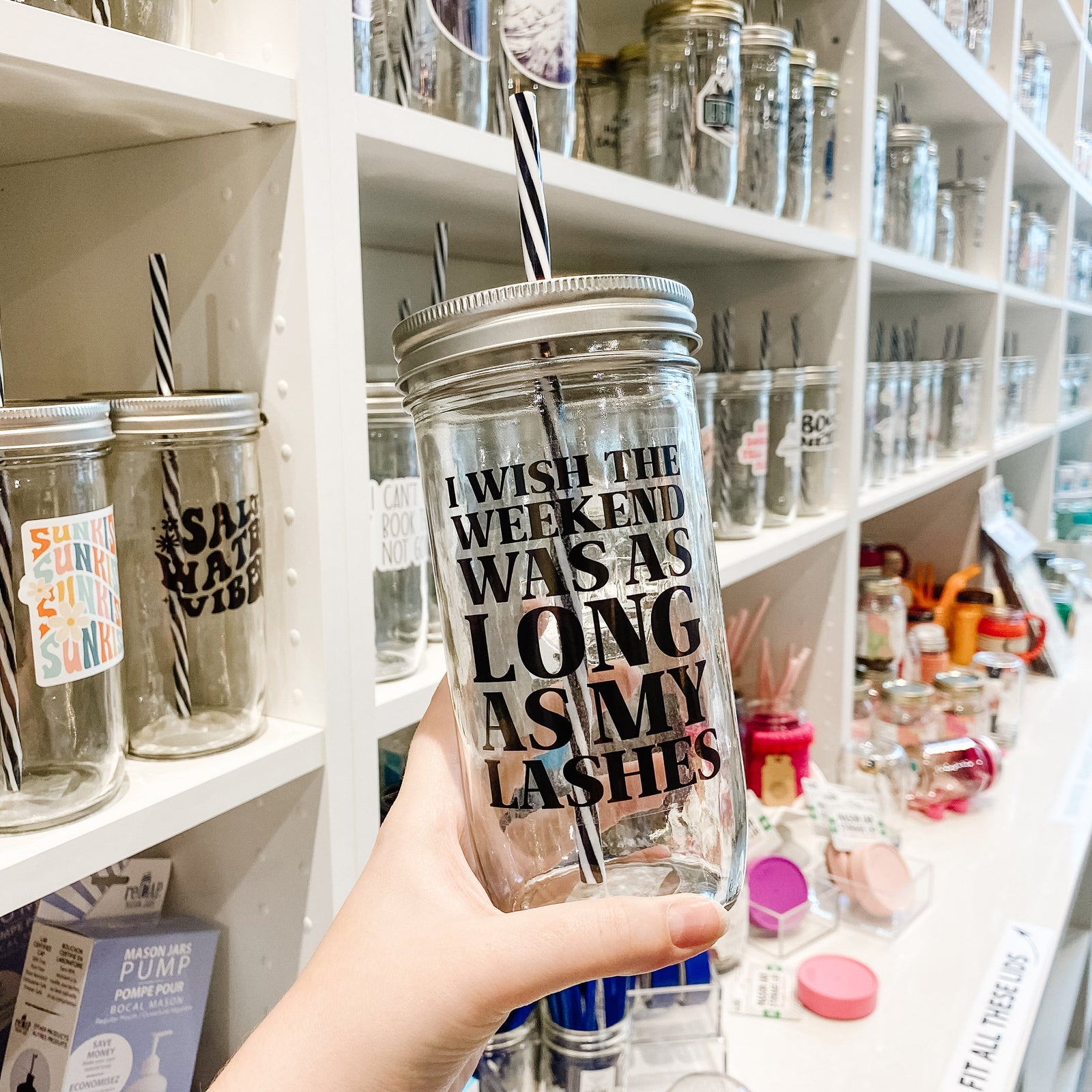 Hand holding a mason jar tumbler that says "I wish the weekend was as long as my lashes”