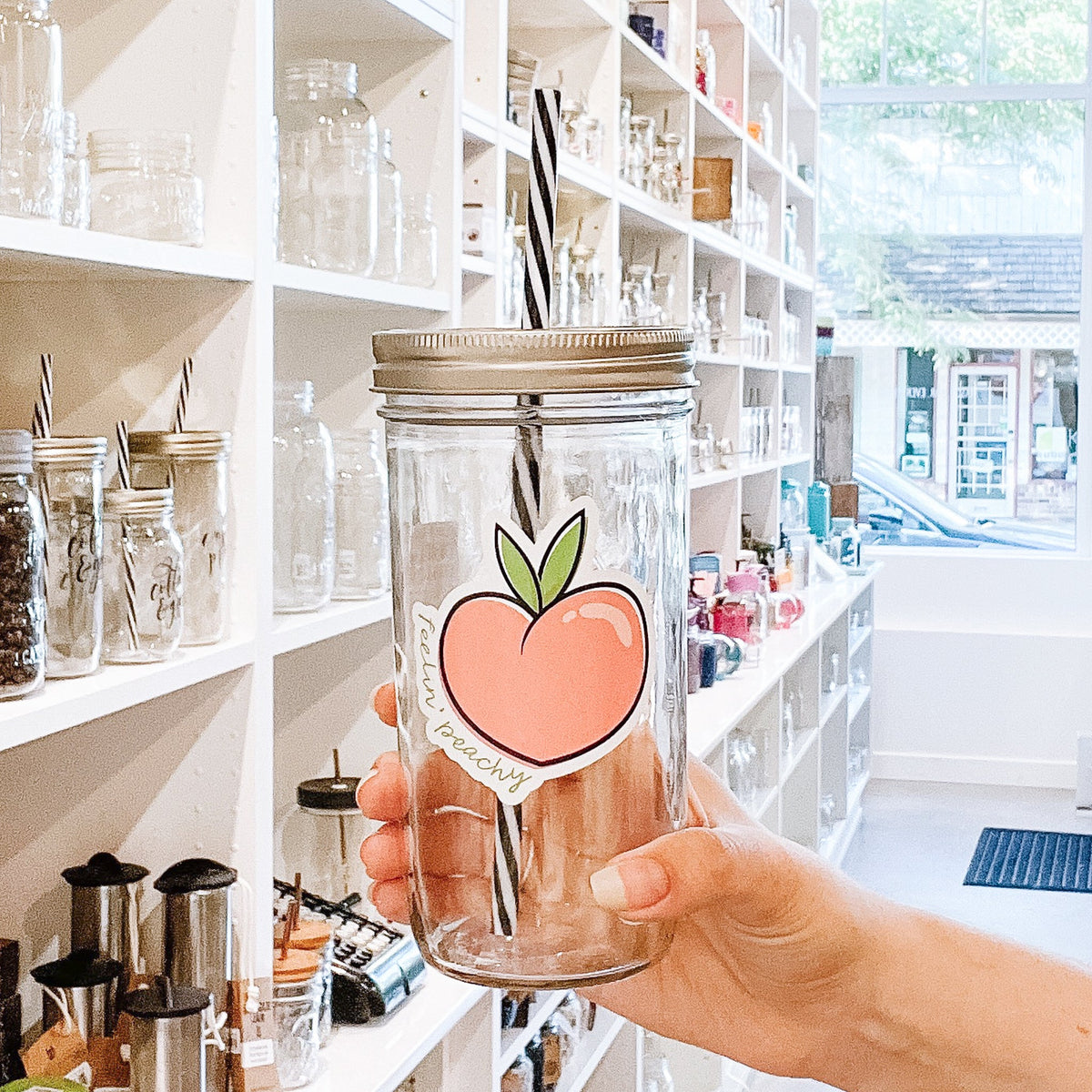 A woman holding Feelin' Peachy Mason Jar Tumbler