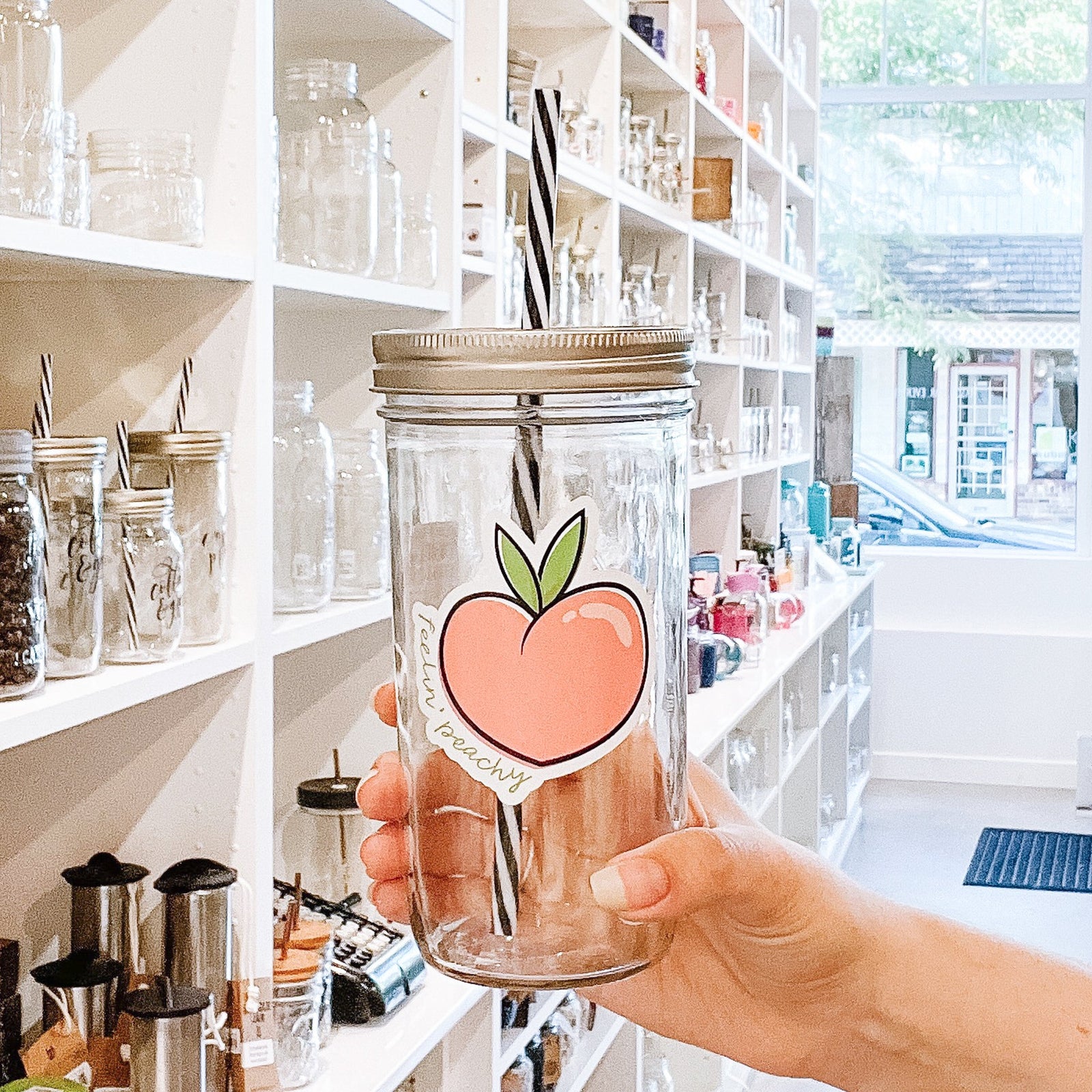 A woman holding Feelin' Peachy Mason Jar Tumbler
