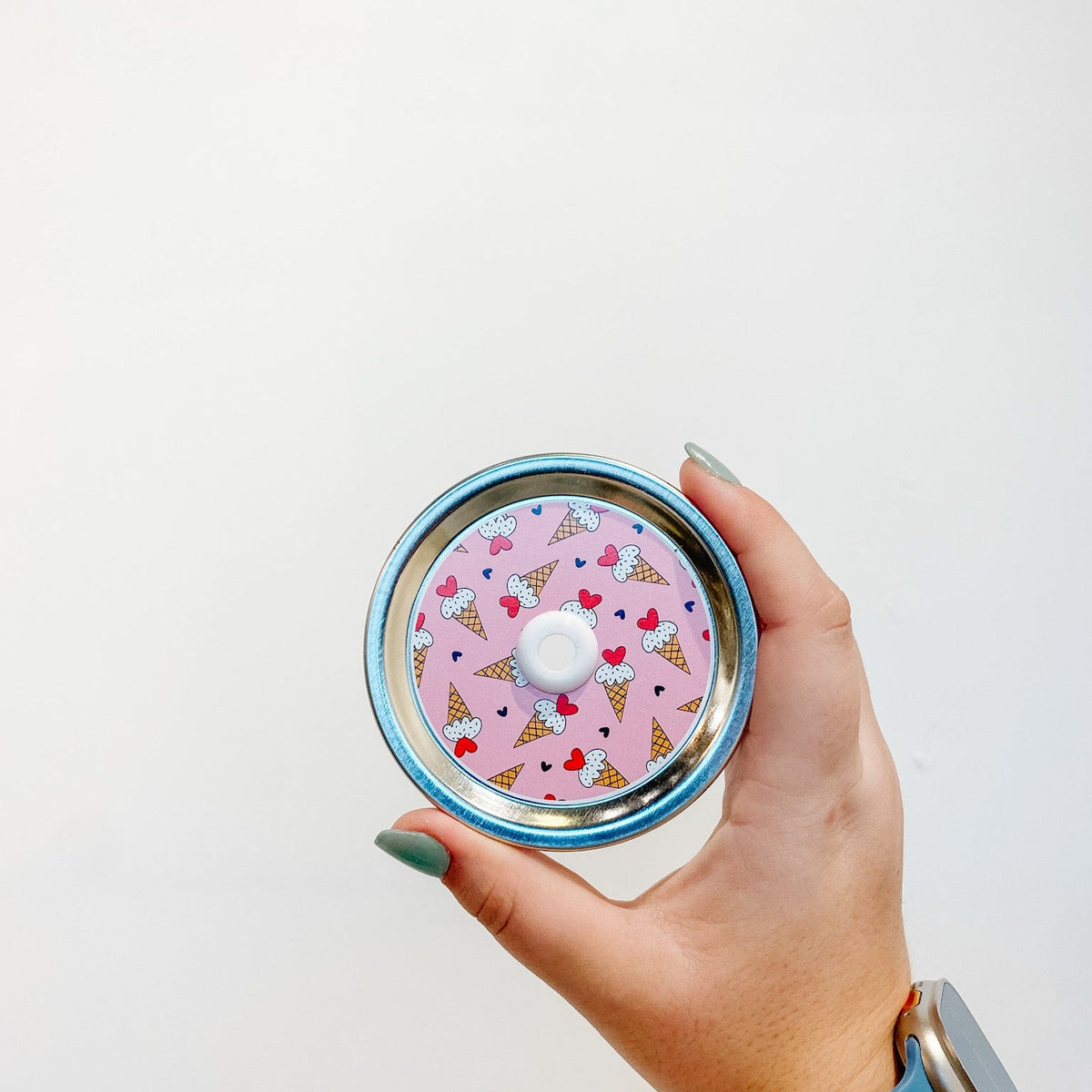 straw lid with ice cream cones on a pink background