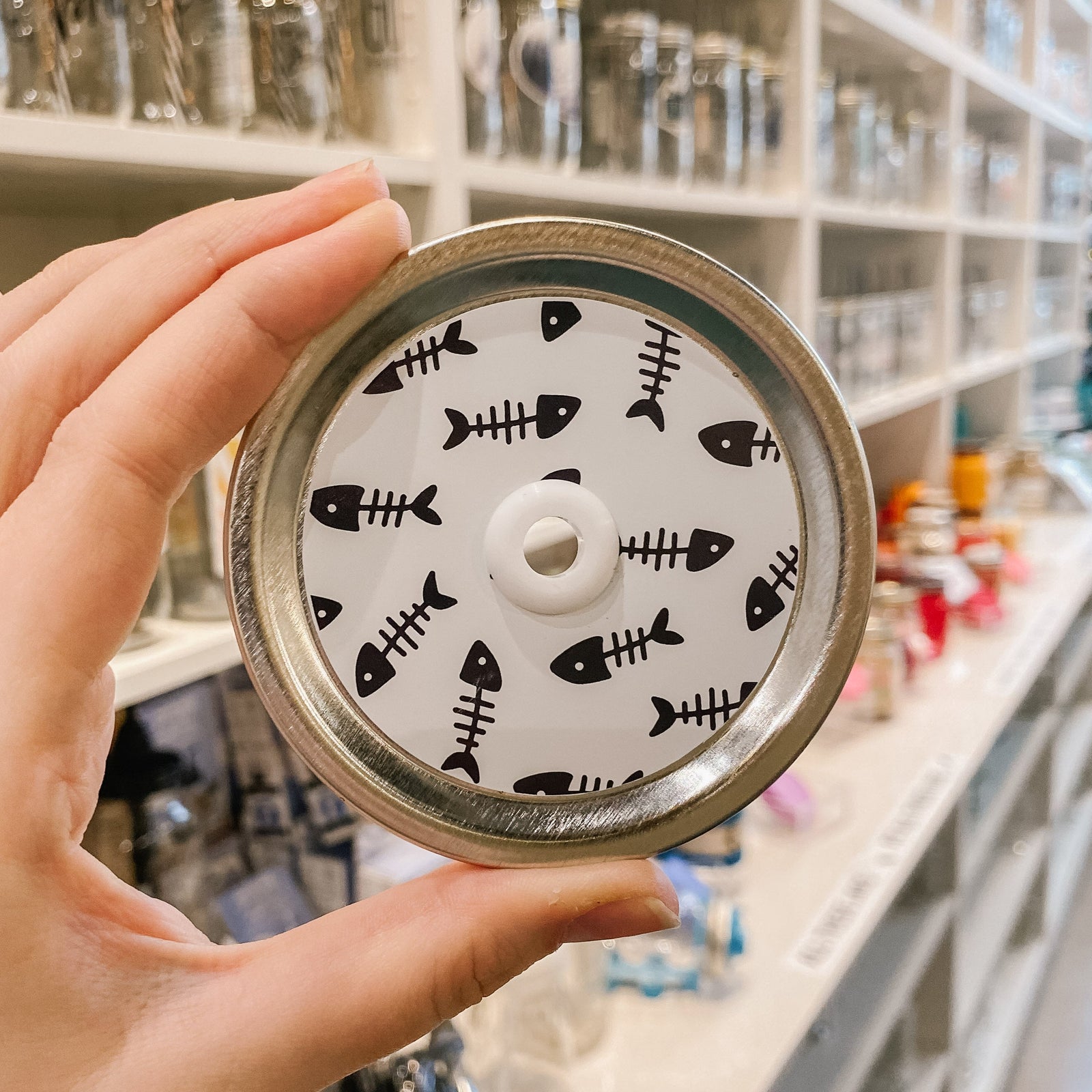 straw lid with white background and black fish skeletons