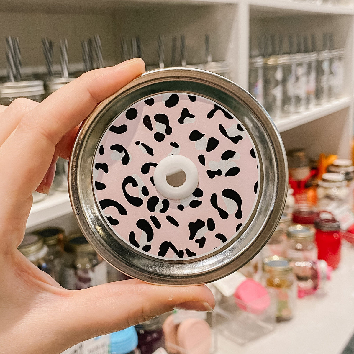 straw lid that has a leopard print on a pink background