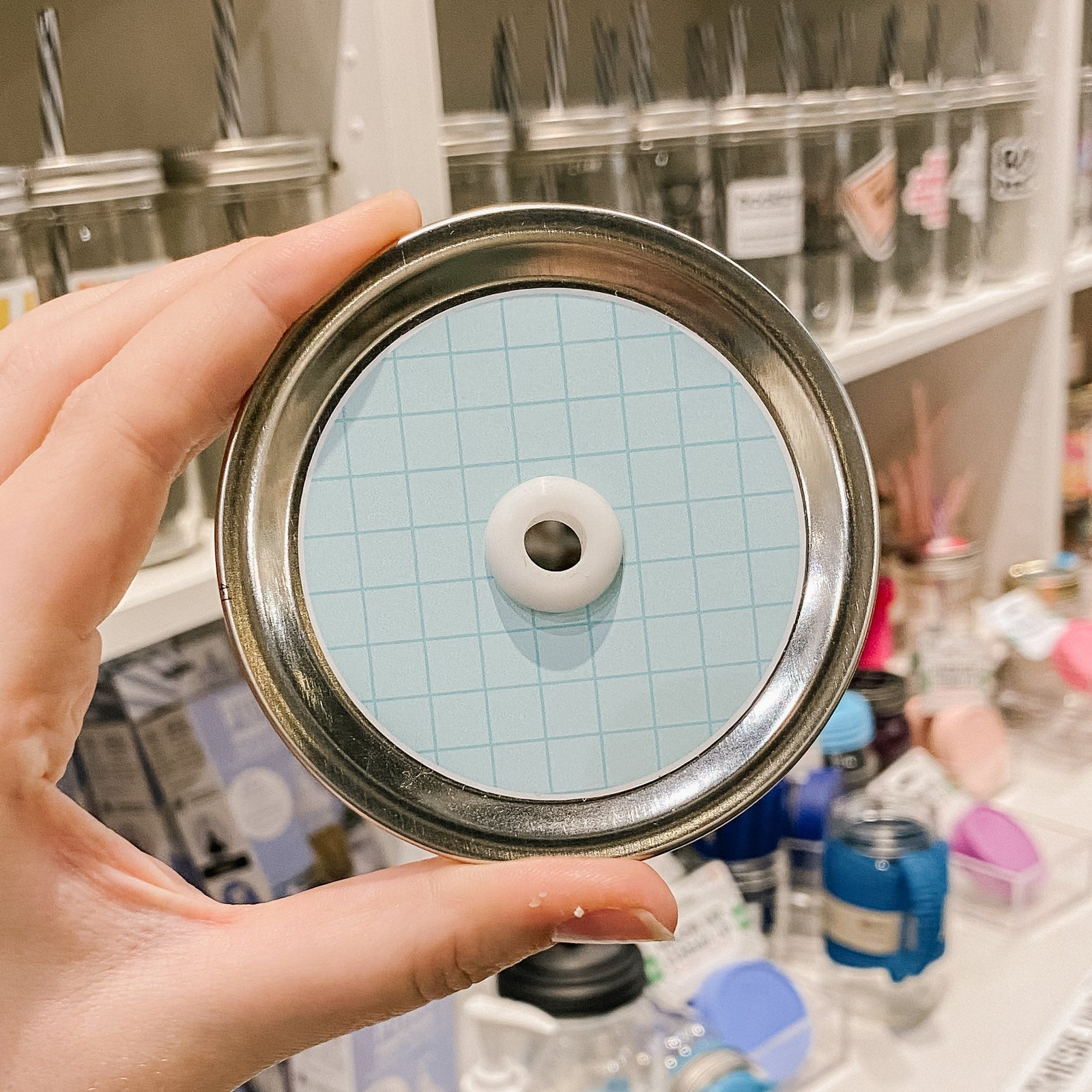 light blue straw lid with a darker blue grid overlayed