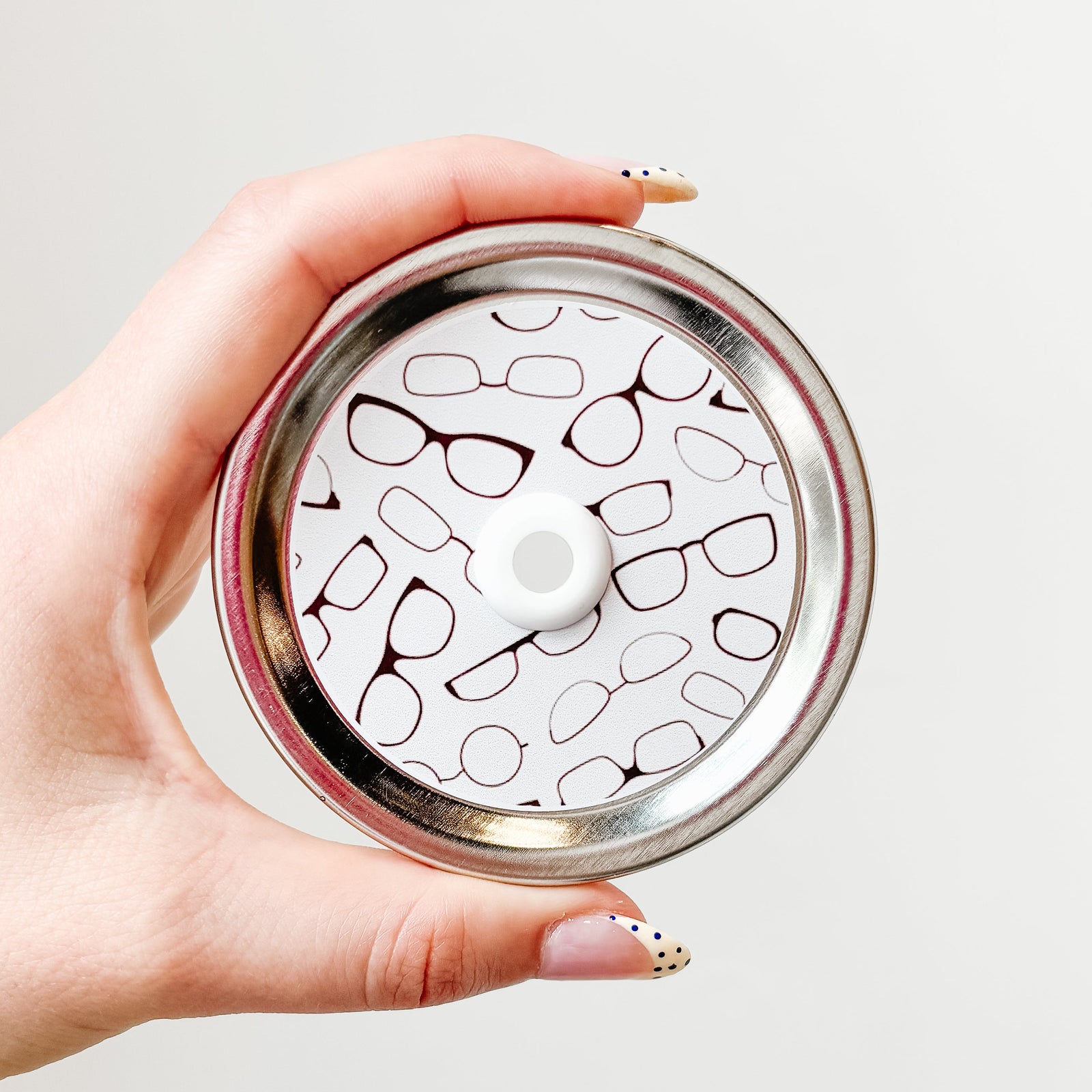 straw lid with white background and different reading glasses across it
