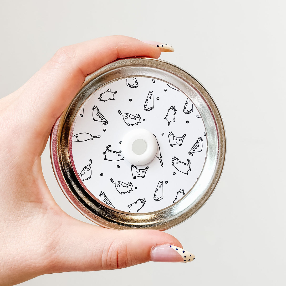 straw lid with a white background with line drawings of cats
