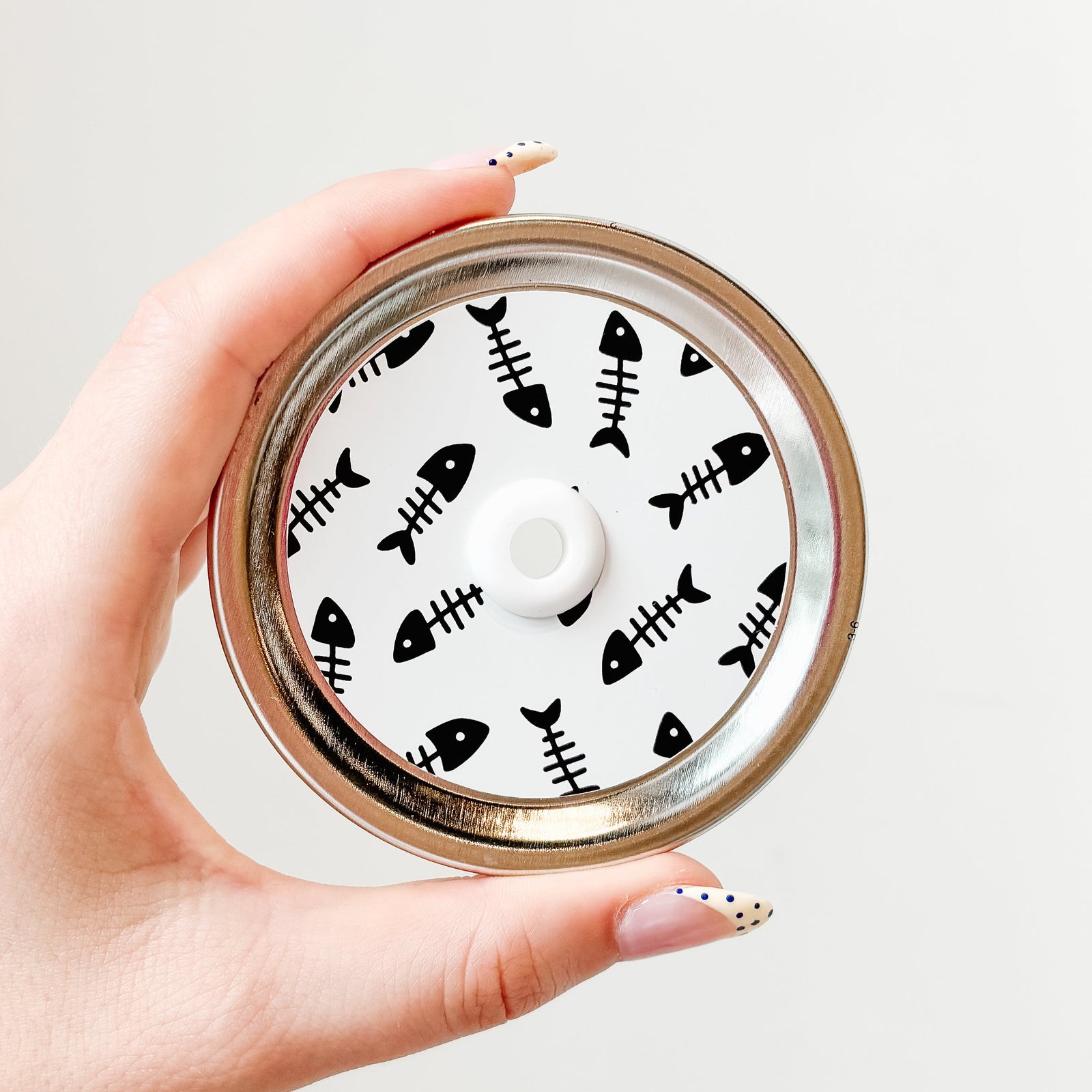 straw lid with white background and black fish skeletons