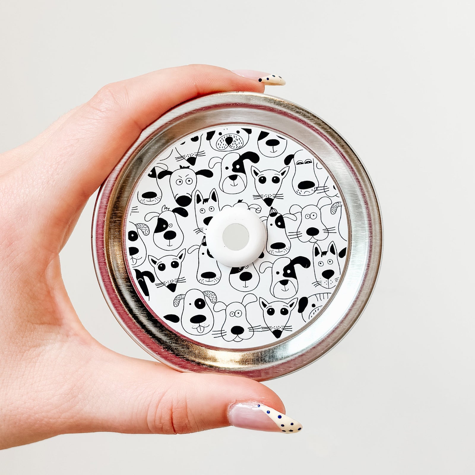 straw lid with white background and black line drawings of different dog faces