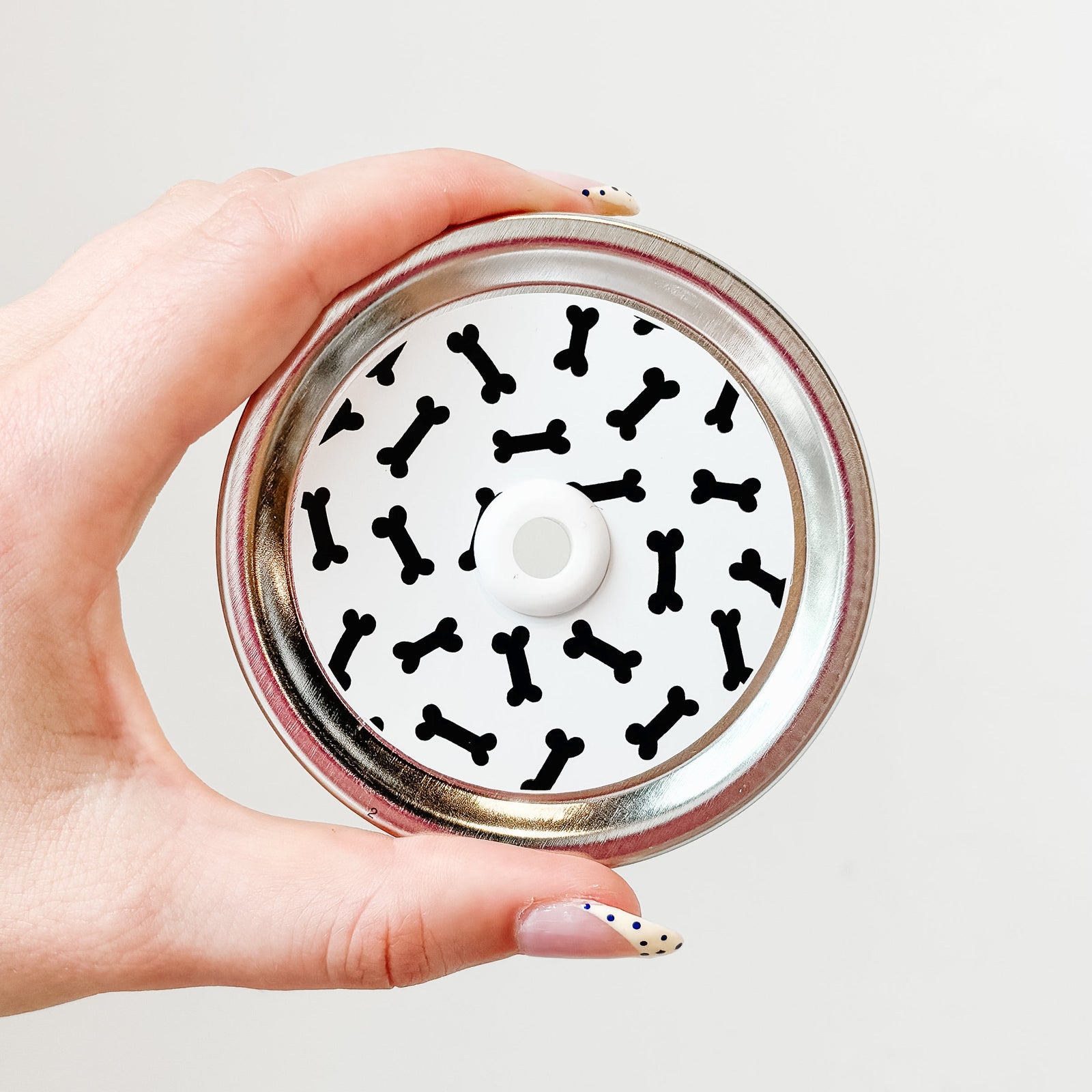 straw lid with white background and black dog bones