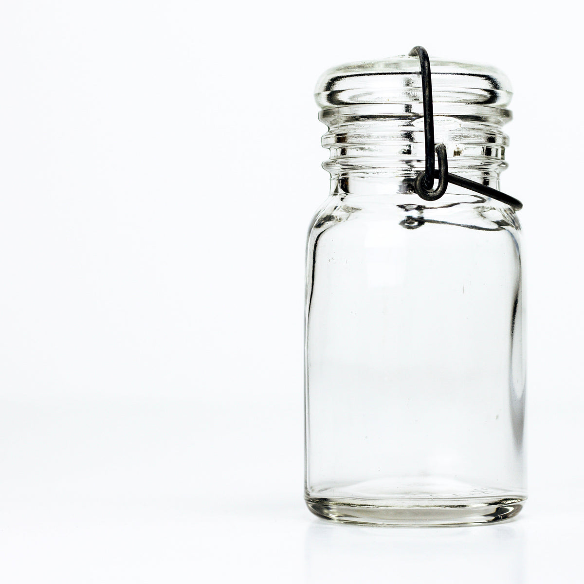 Vintage Wheaton style unmarked 1930s half-pint wire bail mason jar with glass lid, clear product shot on white