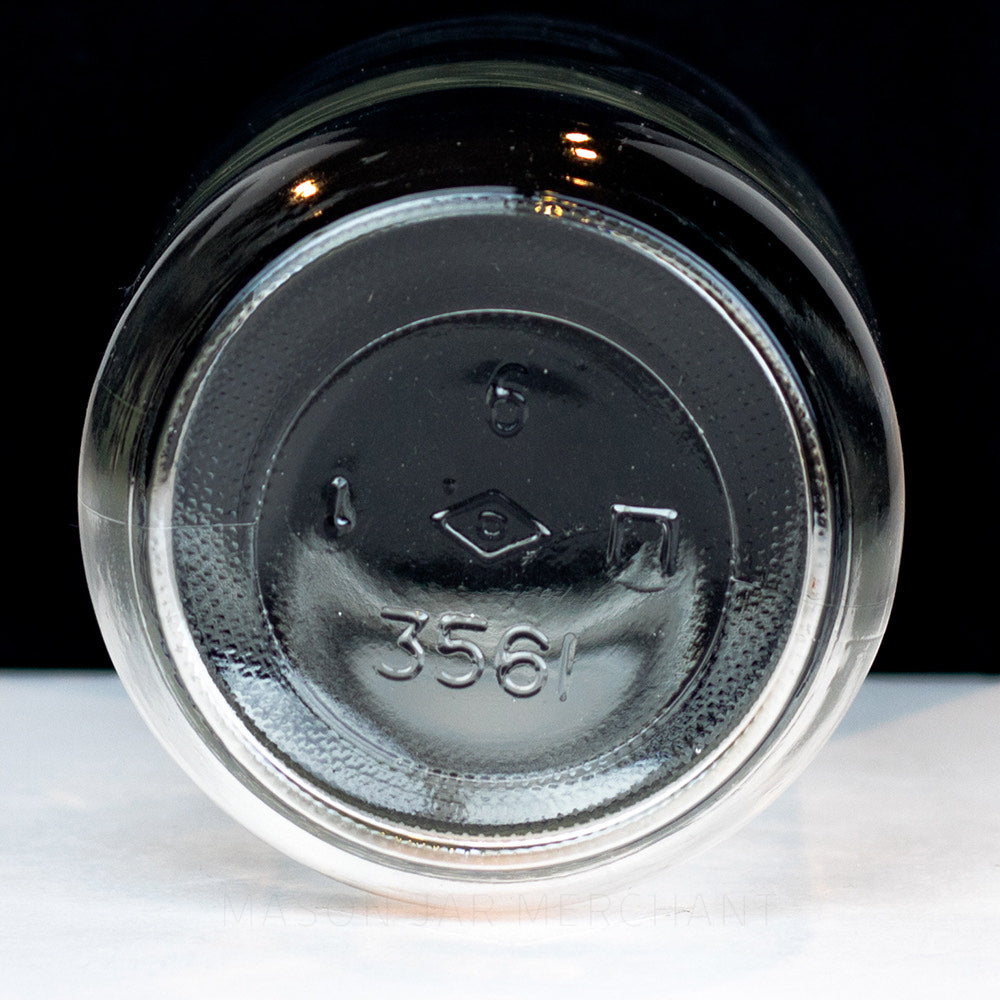 Regular mouth pint mason jar with plain sides, no markings, on a white background