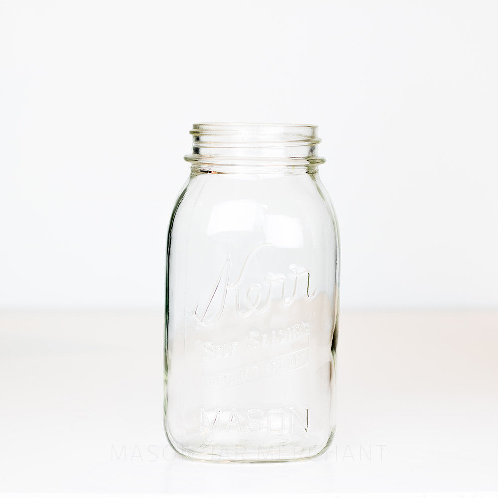 Vintage Kerr Regular Mouth Quart Jar on White Background. Reads Kerr "Self Sealing" [REG. U.S. PAT. OFF.].