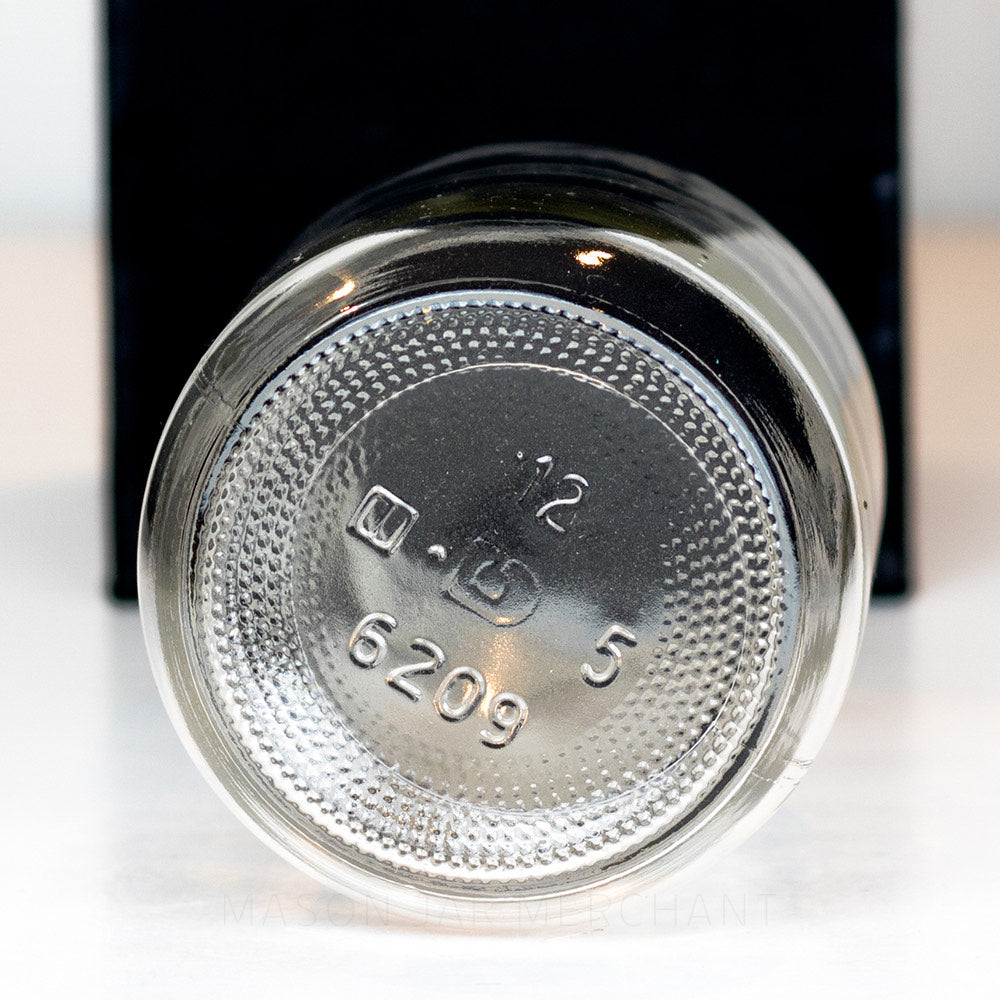 bottom of a Regular mouth pint mason jar with plain sides on a white background