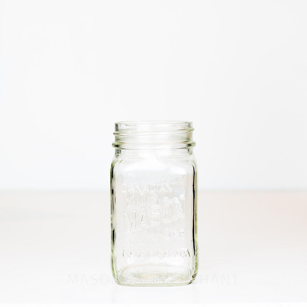 A Canadian Mason - Bocal Mason - Very Square Bilingual Regular Mouth Pint against a white background