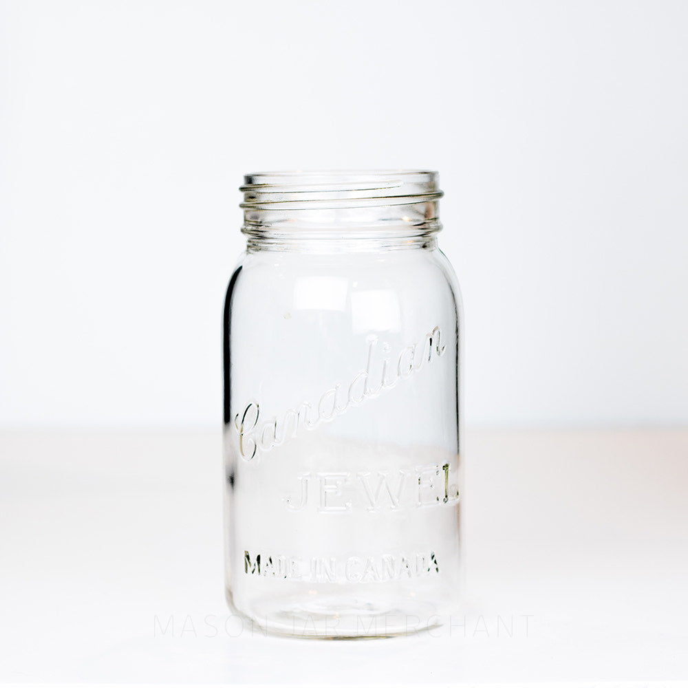 Very old Vintage Canadian Jewel "Made in Canada" Gem Mouth Quart. Has a single triangle marking on the bottom of the jar, photographed on a white background.