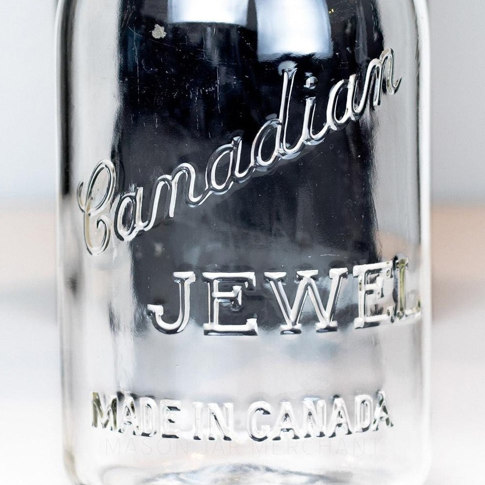 Close-up of a Canadian Jewel logo on a vintage gem mouth mason jar