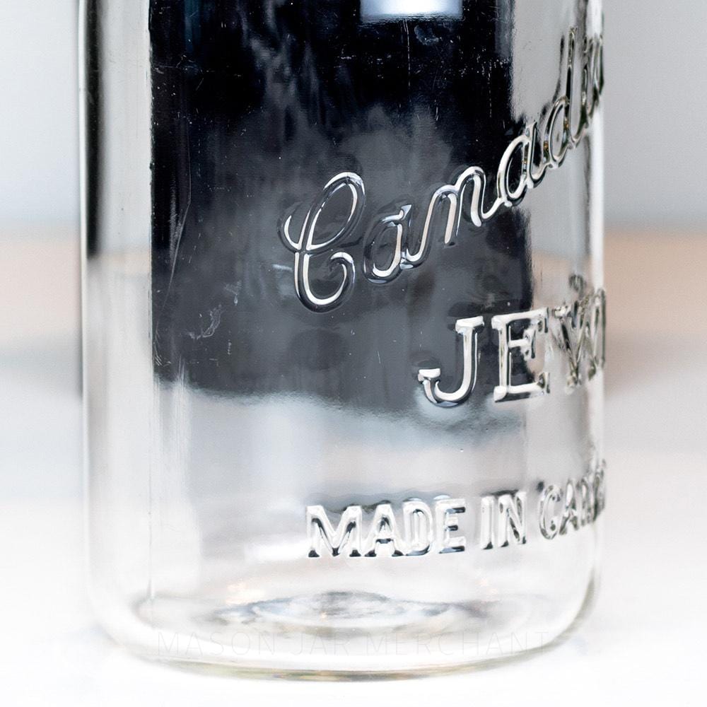 Side view close-up of a Canadian Jewel logo on a vintage gem mouth quart mason jar