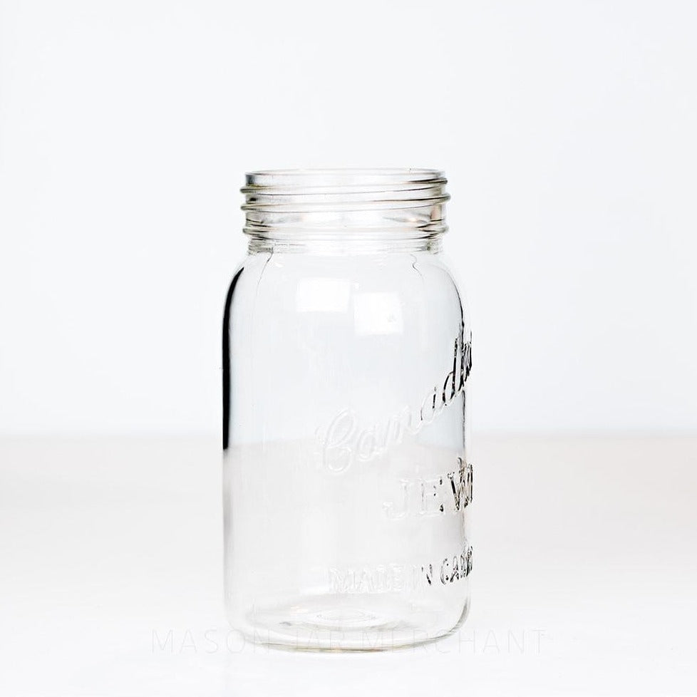 Side view of a vintage Jewel gem mouth quart mason jar against a white background