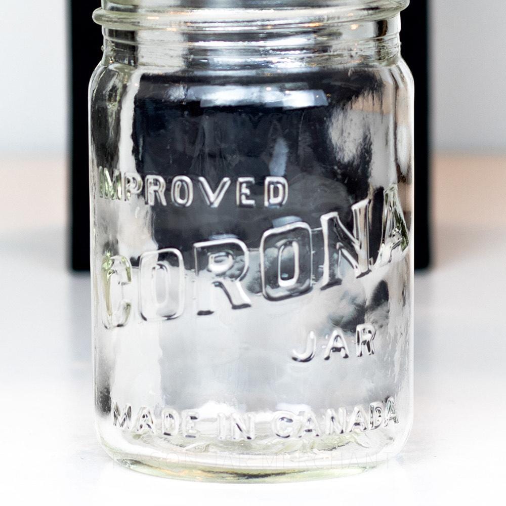 Vintage gem mouth pint mason jar with Improved Corona Jar logo, on a white background
