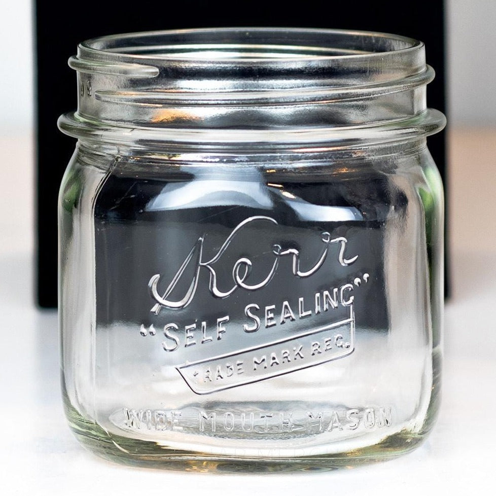Vintage Kerr Self Sealing Short Square Wide Mouth Pint Mason Jar on a white background.