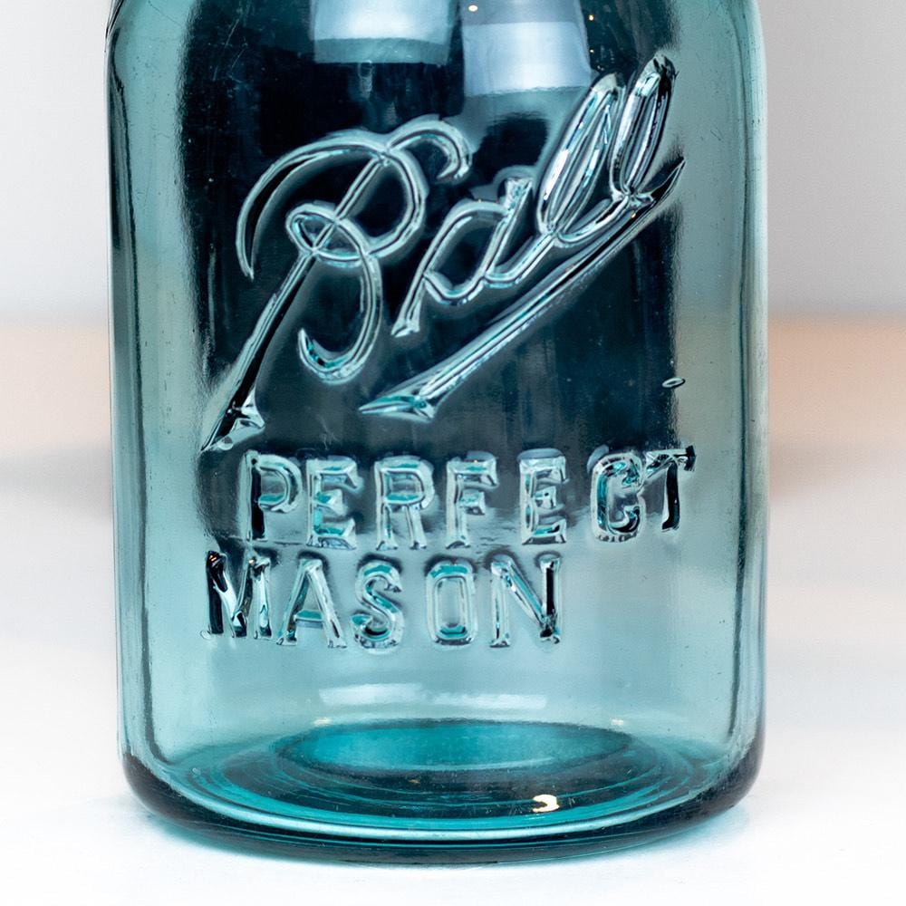 Vintage blue regular mouth quart Ball Perfect Mason jar on a white background