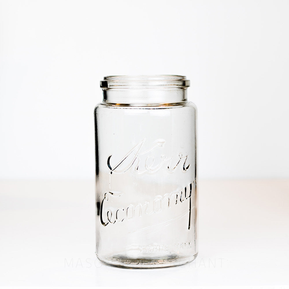 Vintage clamp-top quart mason jar with Kerr Economy logo, on a white background