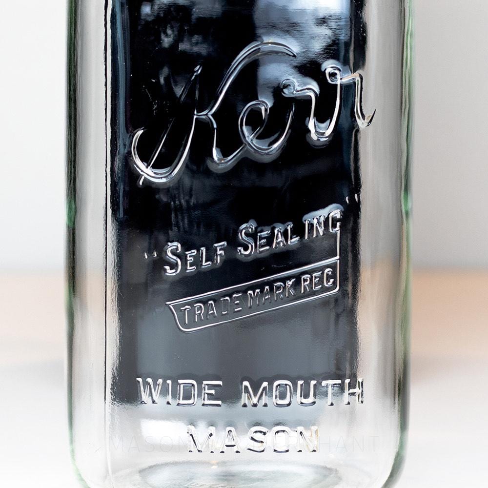 Wide mouth half-gallon mason jar with Kerr Self-sealing trade mark logo on a white background