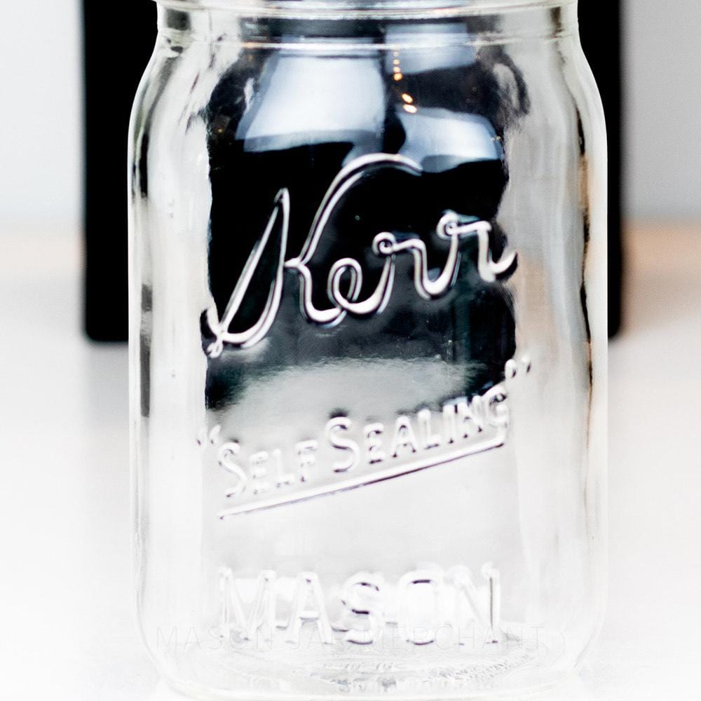 Kerr regular mouth pint mason jar with Self-sealing logo against a white background