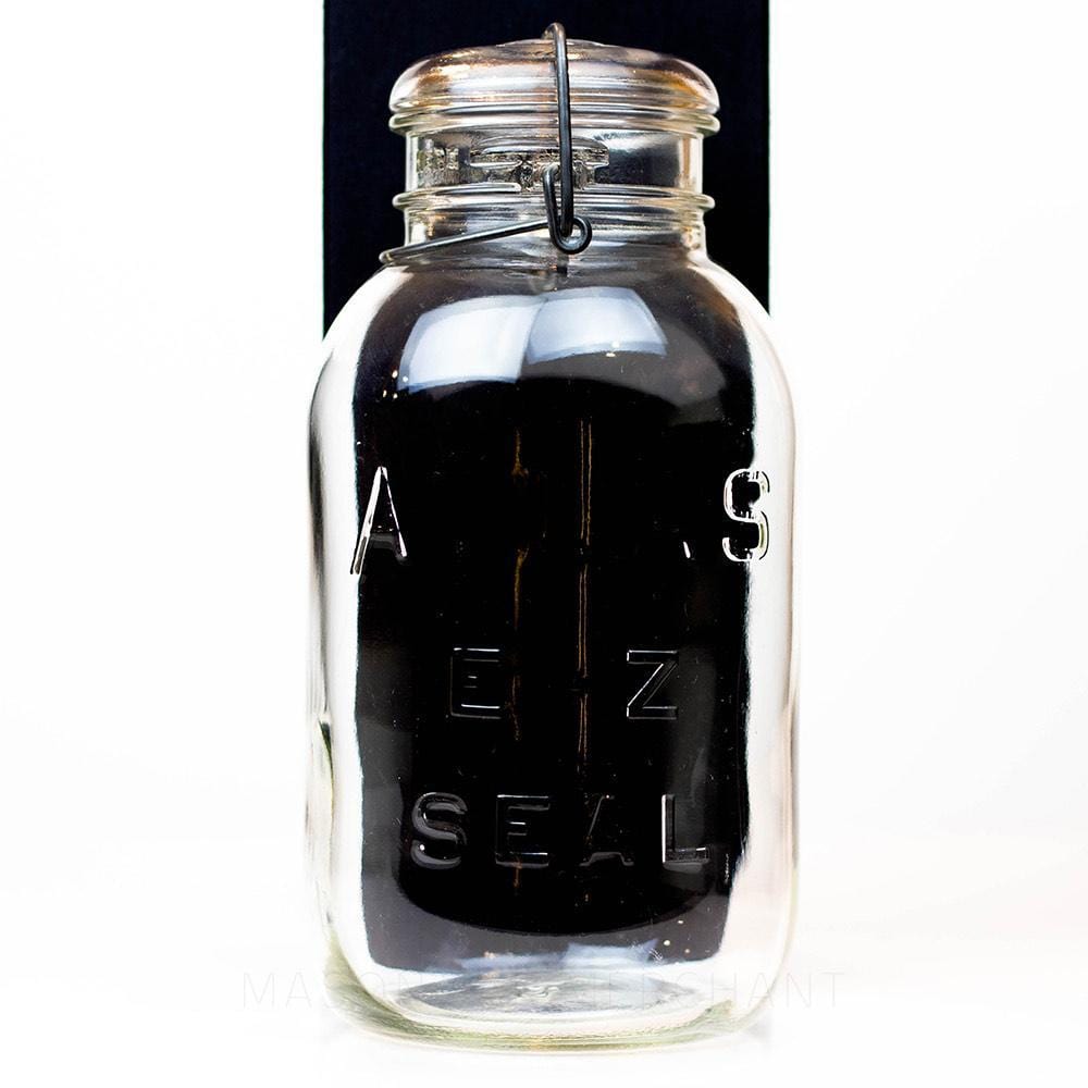 Vintage 1930s wire bail Atlas half gallon mason jar against a white background