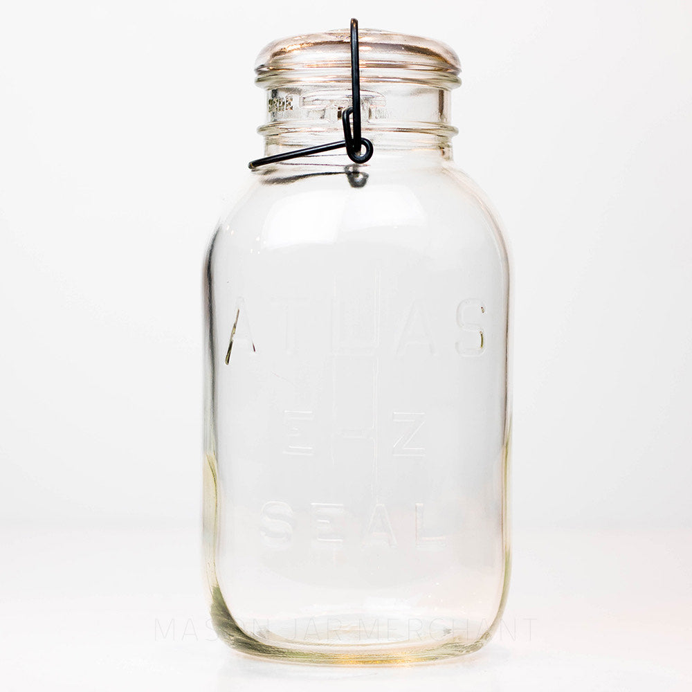 Vintage 1930s wire bail Atlas half gallon mason jar against a white background